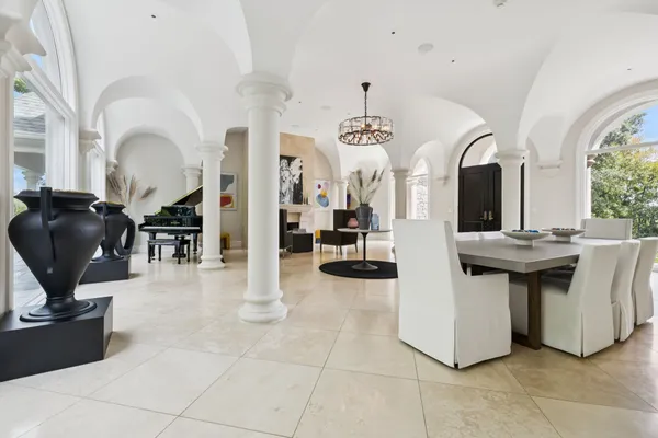 a view of a porch with chairs and backyard