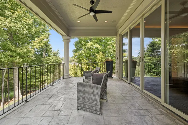 a view of a house with a big yard and large trees