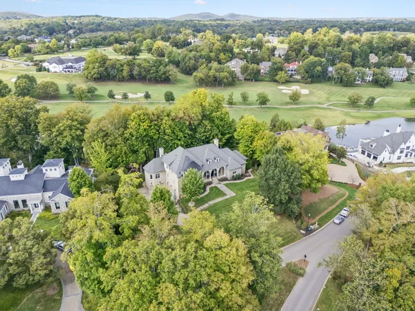 an aerial view of a house with yard