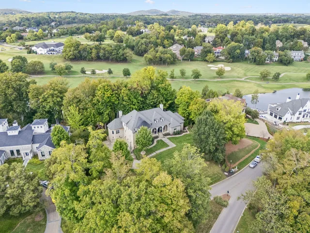 an aerial view of a house with yard