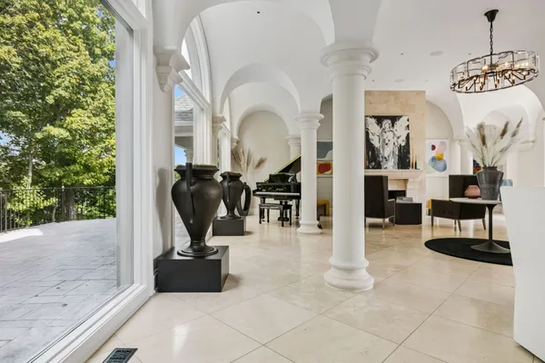 a living room with furniture a rug and white walls