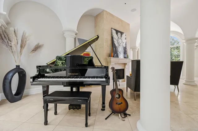 a kitchen with stainless steel appliances granite countertop a sink a window and white cabinets