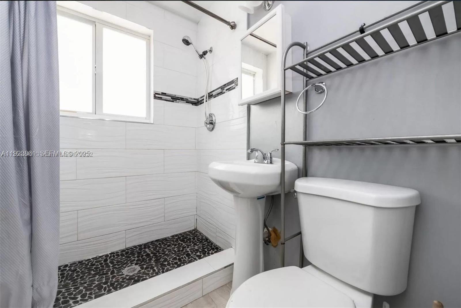 610 12th Street, Unit 5 Miami Beach, FL 33139 - Photo 6 of 8 a bathroom with a sink toilet and shower