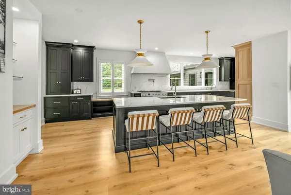 a kitchen with a table chairs refrigerator and window