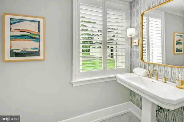 a bathroom with a sink and a large mirror