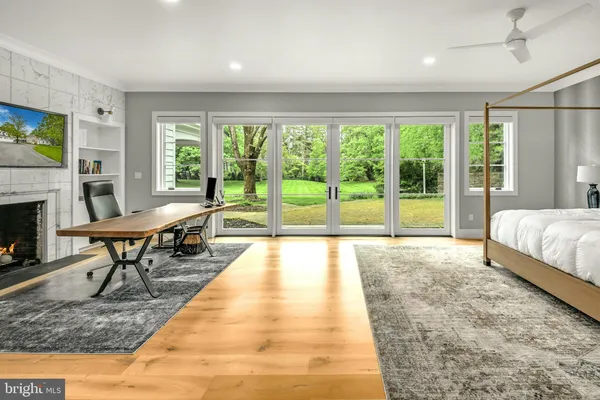 a spacious bedroom with a bed and a large window