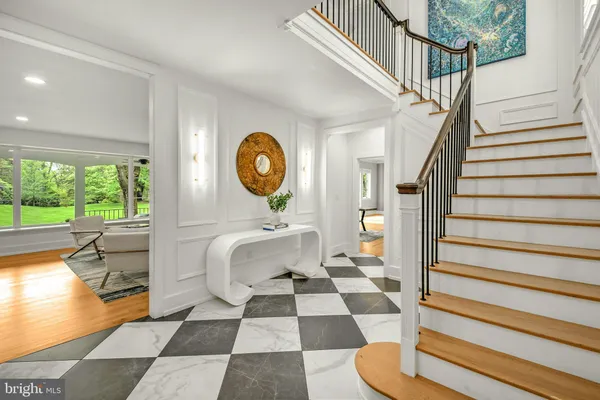 a living room with a rug floor to ceiling window and a rug