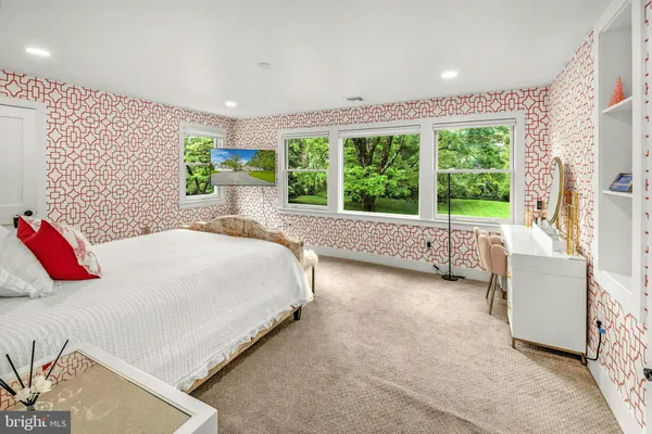 a bedroom with a bed and a large window