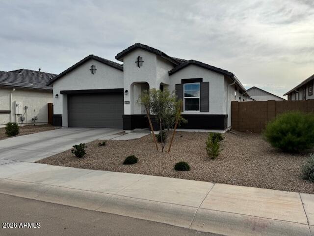 39995 West Agave Road Maricopa, AZ 85138 - Photo 1 of 26 a front view of a house with garage