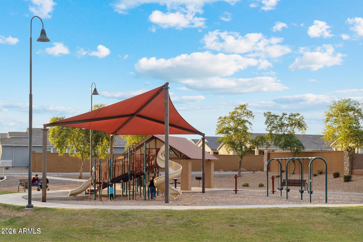 39995 West Agave Road Maricopa, AZ 85138 - Photo 24 of 26 a view of a swimming pool with a table and chairs
