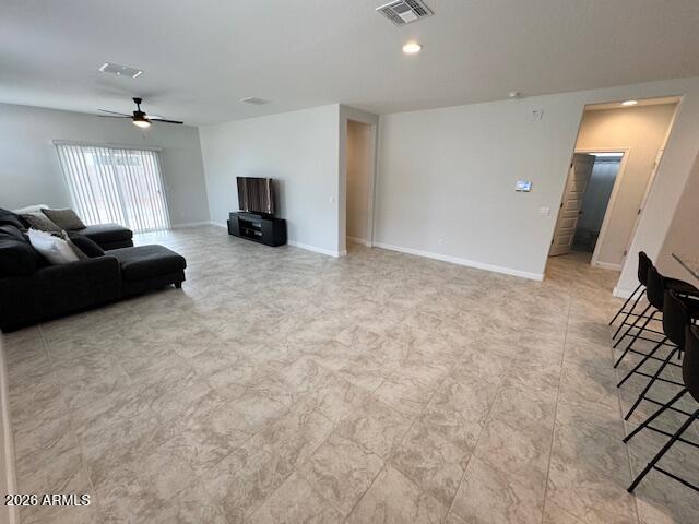 39995 West Agave Road Maricopa, AZ 85138 - Photo 4 of 26 a living room with furniture and a flat screen tv