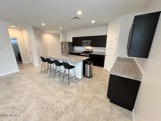 39995 West Agave Road Maricopa, AZ 85138 - Photo 6 of 26 a view of kitchen with microwave stove refrigerator dining table and chairs