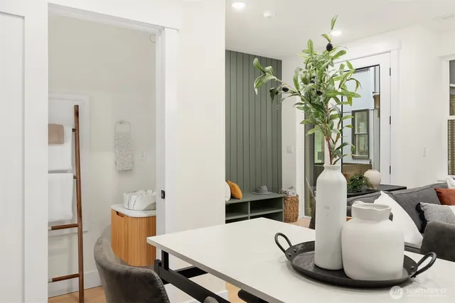 a dining room with furniture and a potted plant