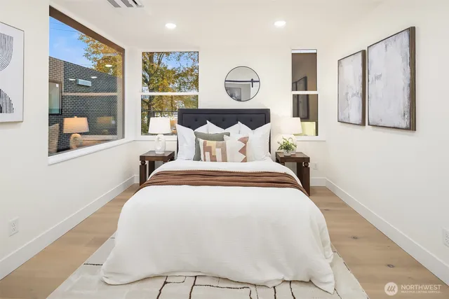 a bed room with a bed mirror and a night stand