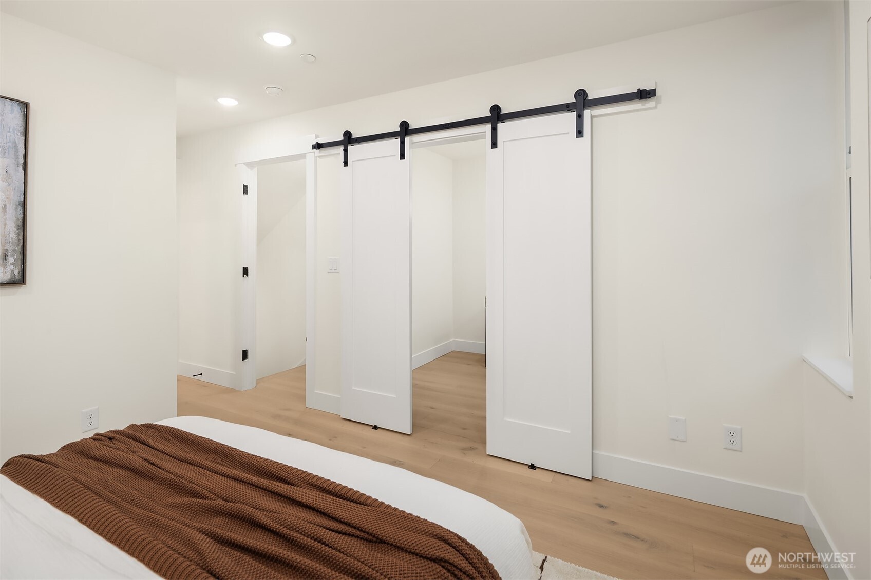 2018 Fairview Avenue East, Unit B Seattle, WA 98102 - Photo 15 of 17 a bedroom with a bed and wooden floor