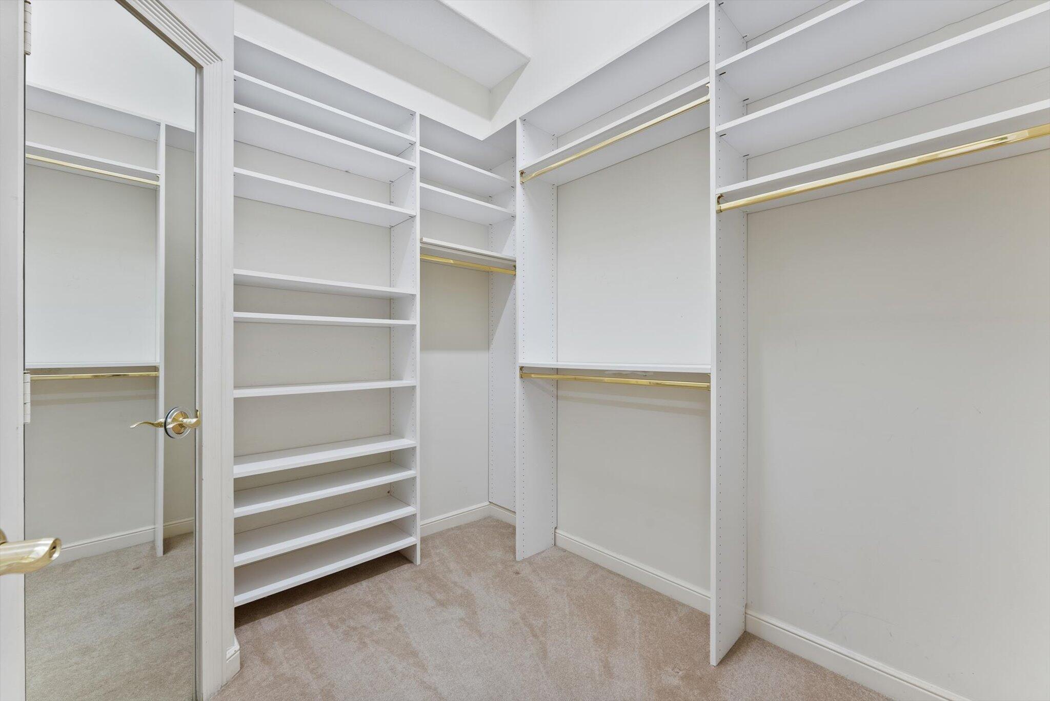 7081 Mallorca Crescent Boca Raton, FL 33433 - Photo 13 of 26 a view of walk in closet with empty racks