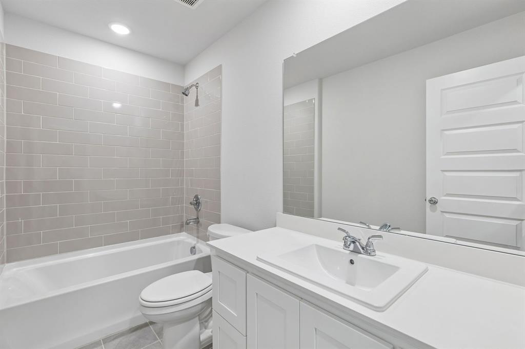 671 Sierra Ridge Lavon, TX 75166 - Photo 28 of 33 a bathroom with a sink a toilet and bathtub