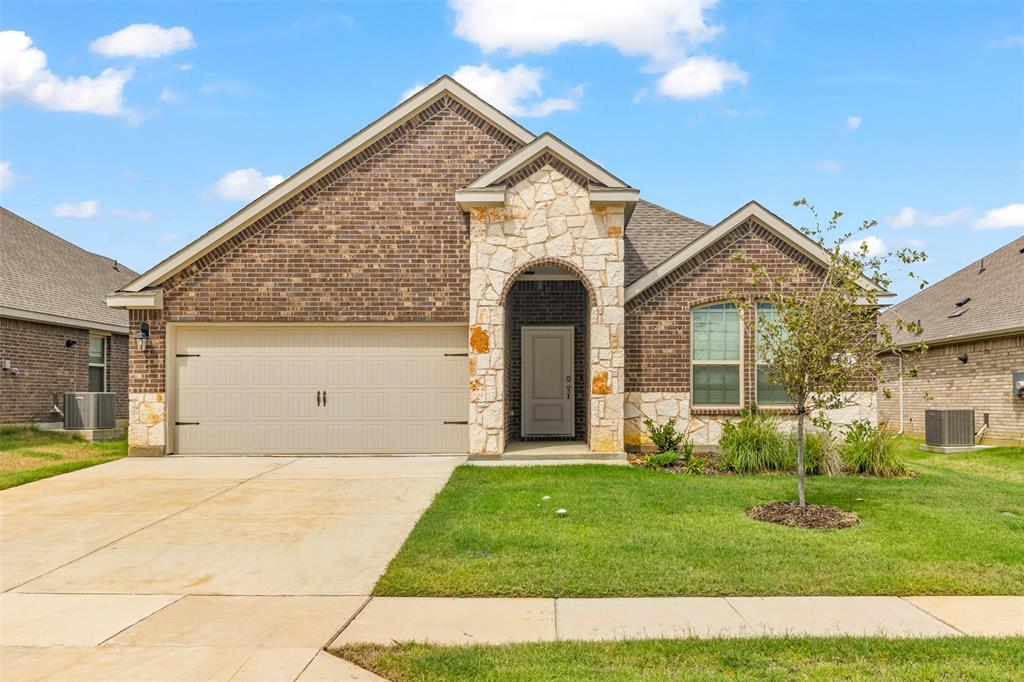 10305 Rambling Brks Lane Aubrey, TX 76227 - Photo 1 of 28 a front view of a house with a yard and garage