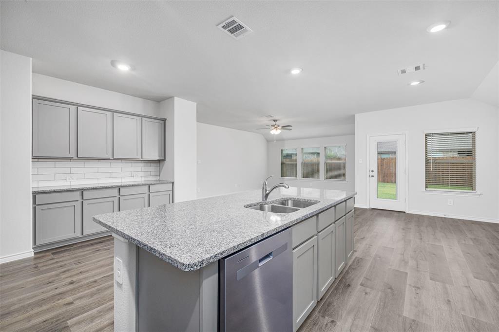 10305 Rambling Brks Lane Aubrey, TX 76227 - Photo 14 of 28 a kitchen with a sink and cabinets