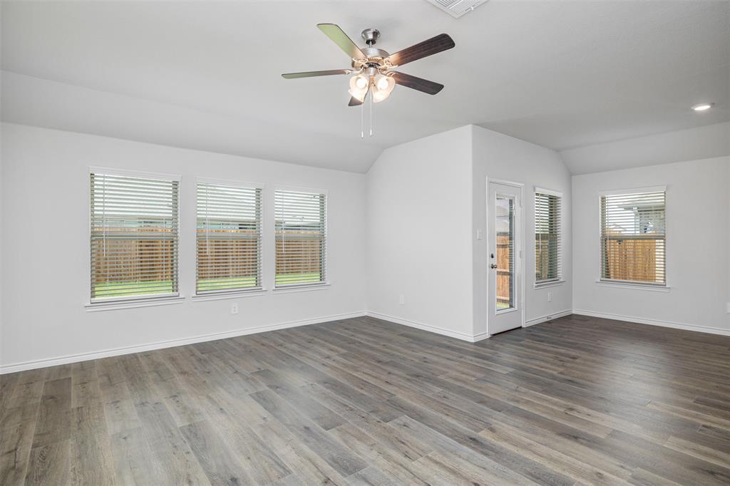 10305 Rambling Brks Lane Aubrey, TX 76227 - Photo 17 of 28 a view of an empty room with window and wooden floor