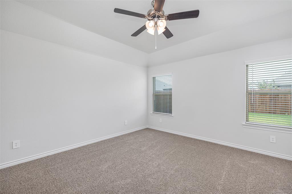 10305 Rambling Brks Lane Aubrey, TX 76227 - Photo 18 of 28 an empty room with a window and a fan