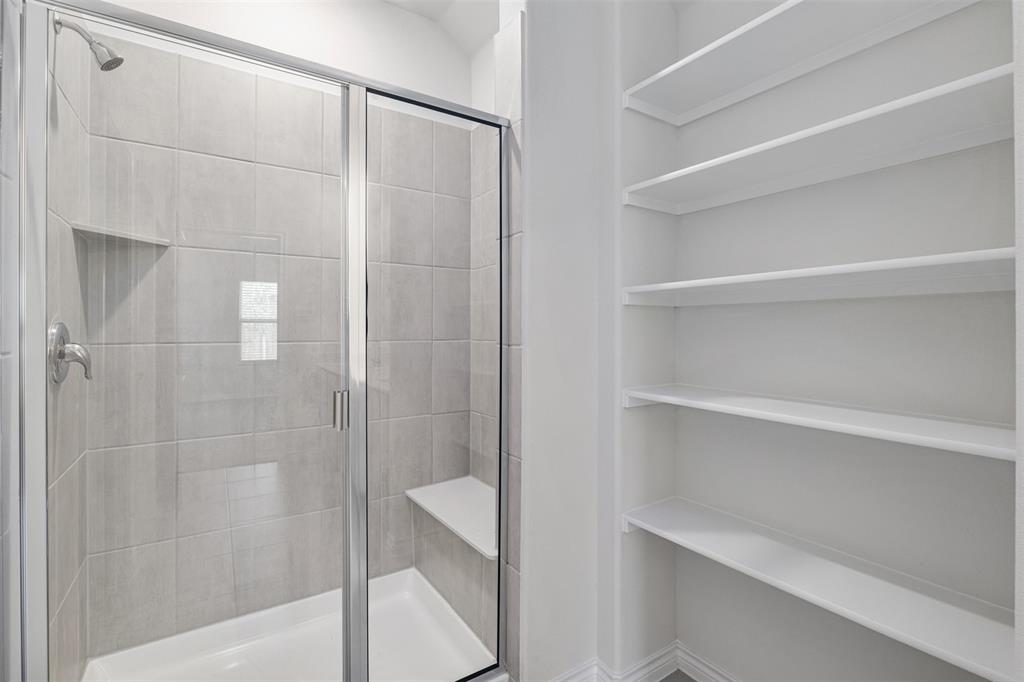 10305 Rambling Brks Lane Aubrey, TX 76227 - Photo 23 of 28 a bathroom with a shower