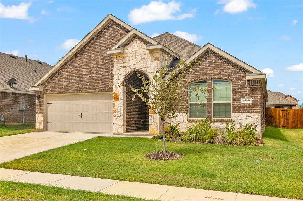 10305 Rambling Brks Lane Aubrey, TX 76227 - Photo 3 of 28 a front view of a house with a yard