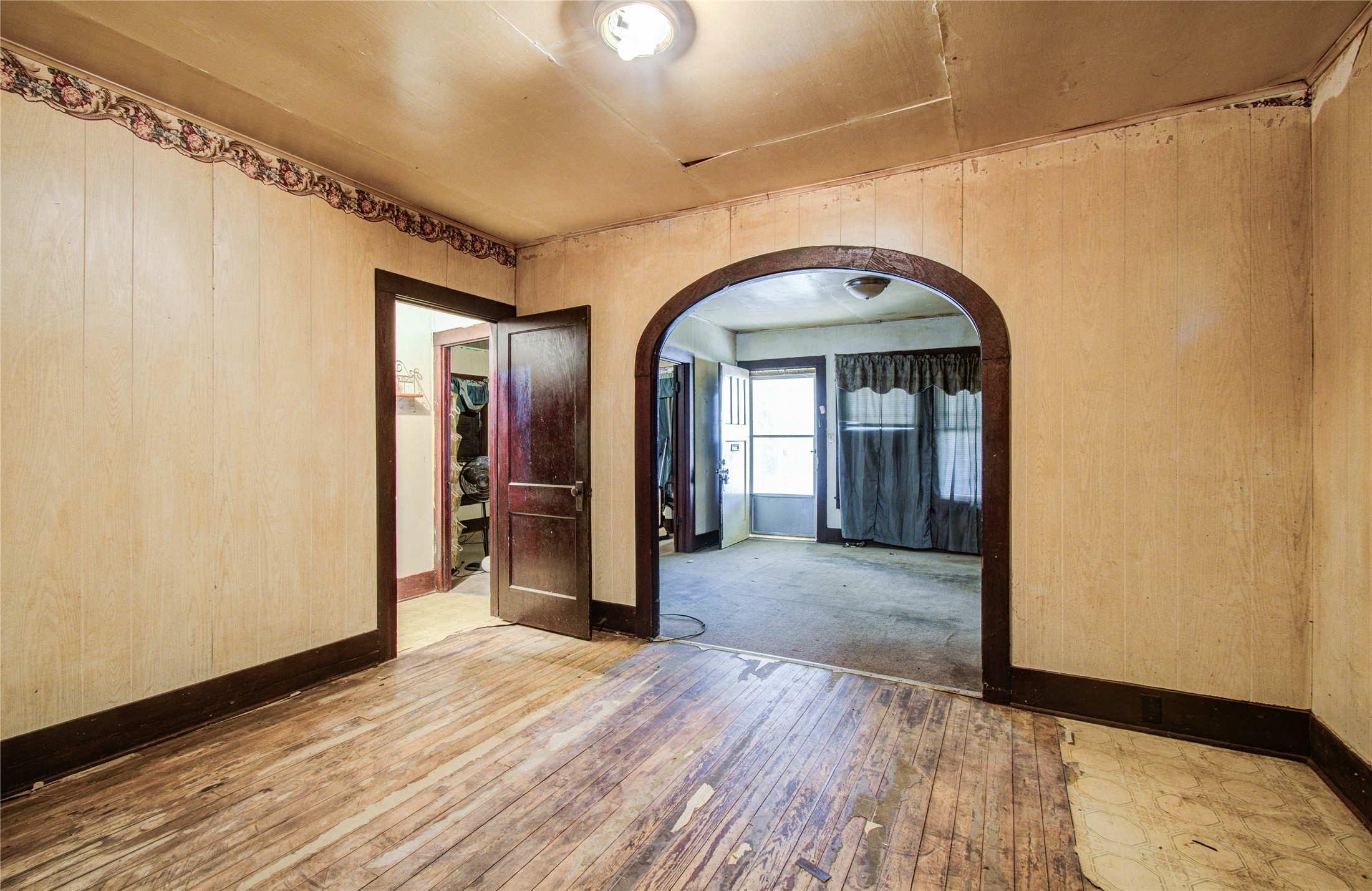 1003 Prairie Street Columbus, TX 78934 - Photo 8 of 29 a view of a hallway with wooden floor and a bathroom