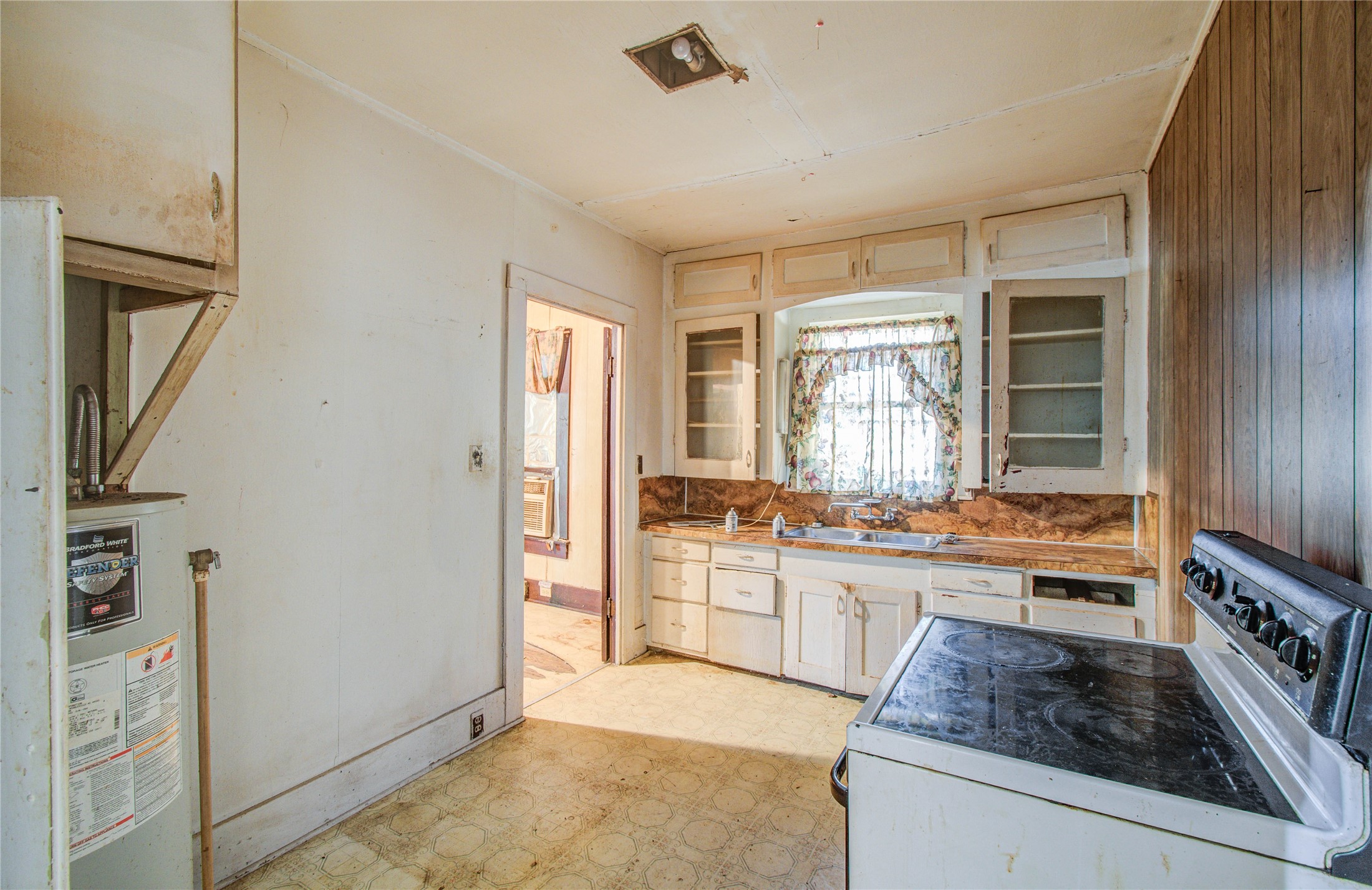 1003 Prairie Street Columbus, TX 78934 - Photo 10 of 29 a large kitchen with kitchen island a large counter top space a stove a refrigerator and cabinets
