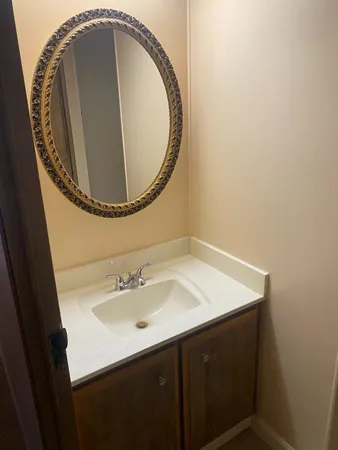 a bathroom with a sink and a mirror