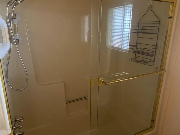 a bathroom with a glass shower door