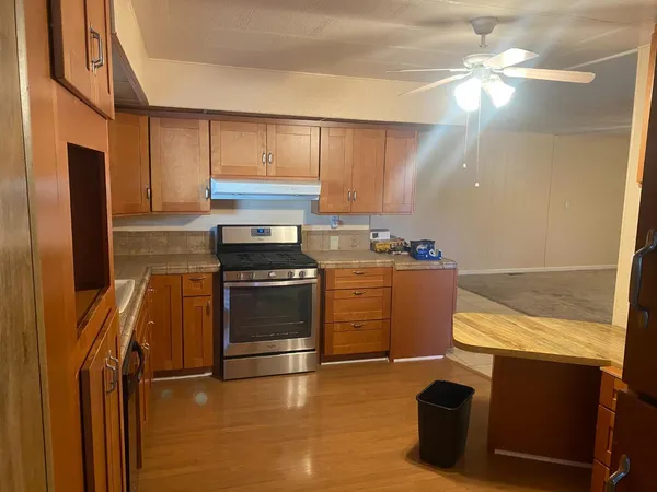 a kitchen with granite countertop a stove and a refrigerator