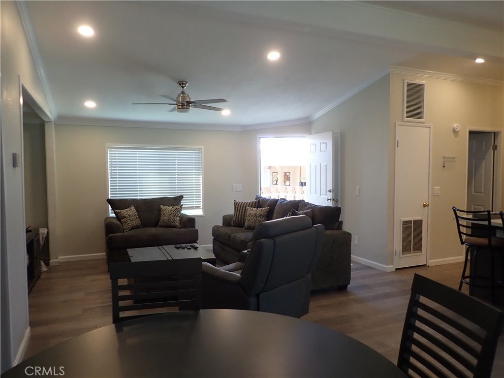 27250 Murrieta Road, Unit 386 Menifee, CA 92586 - Photo 19 of 32 a living room with furniture a ceiling fan and a window