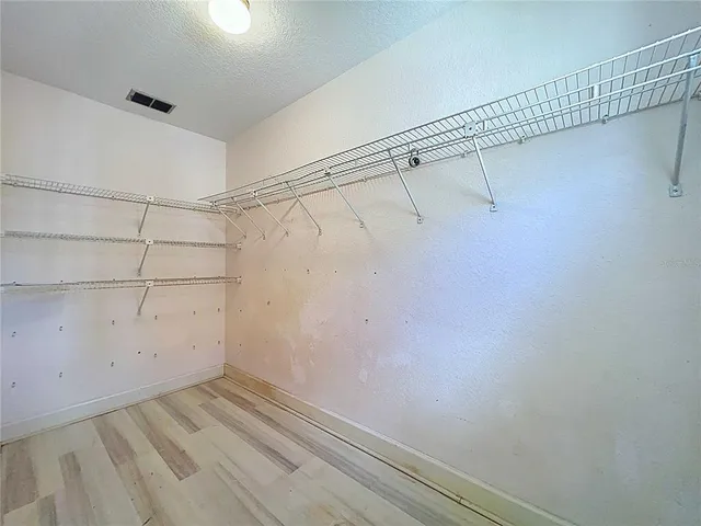 a kitchen with granite countertop white cabinets stainless steel appliances and a sink