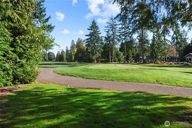 a sign that is sitting in the middle of a garden