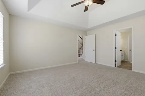 an empty room with a ceiling fan and a window
