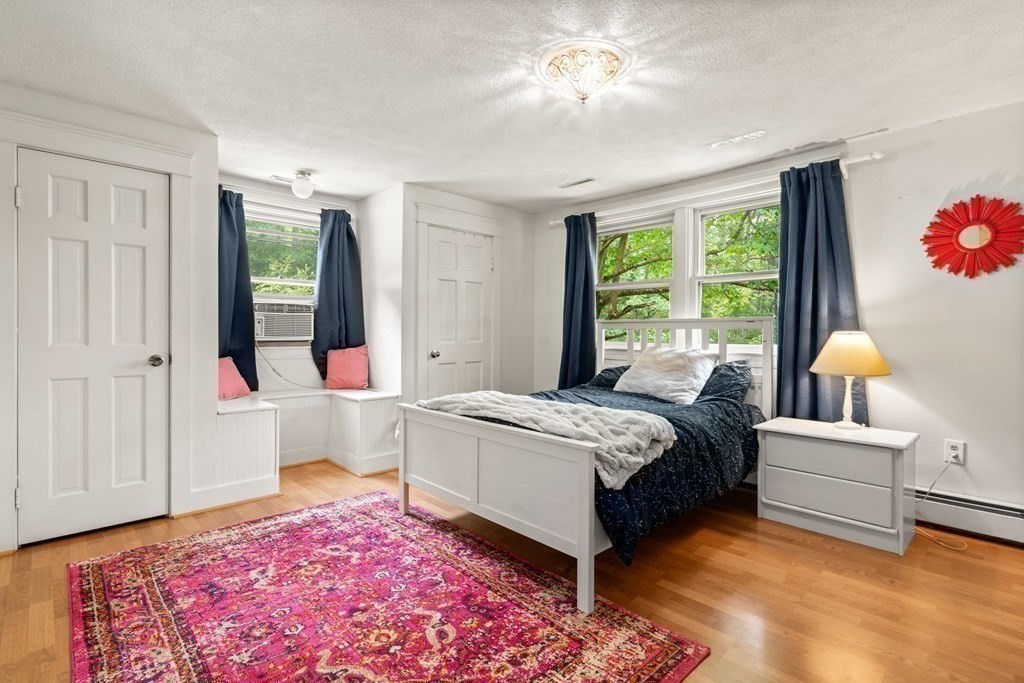 114 Still River Road Harvard, MA 01451 - Photo 22 of 42 a bedroom with a large bed and a chandelier