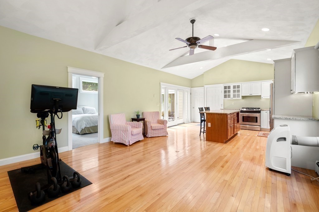 114 Still River Road Harvard, MA 01451 - Photo 33 of 42 a living room with furniture a chandelier and a flat screen tv