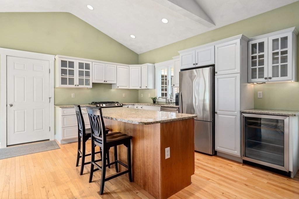 114 Still River Road Harvard, MA 01451 - Photo 34 of 42 a kitchen with stainless steel appliances granite countertop a refrigerator a stove a sink and a dining table with wooden floor