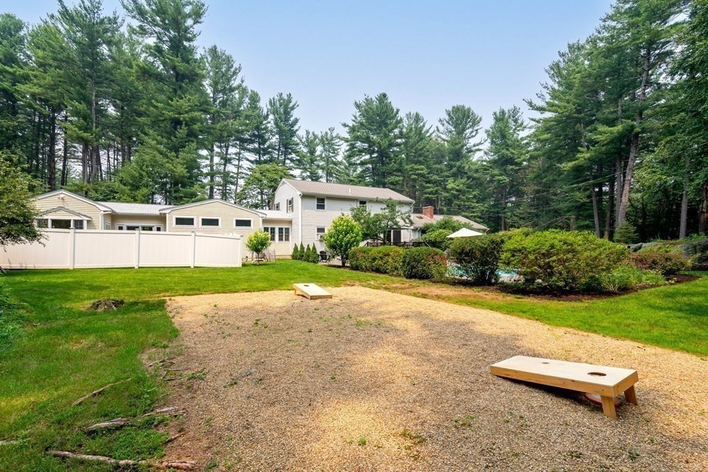 114 Still River Road Harvard, MA 01451 - Photo 39 of 42 a view of a backyard with lawn chairs and large trees