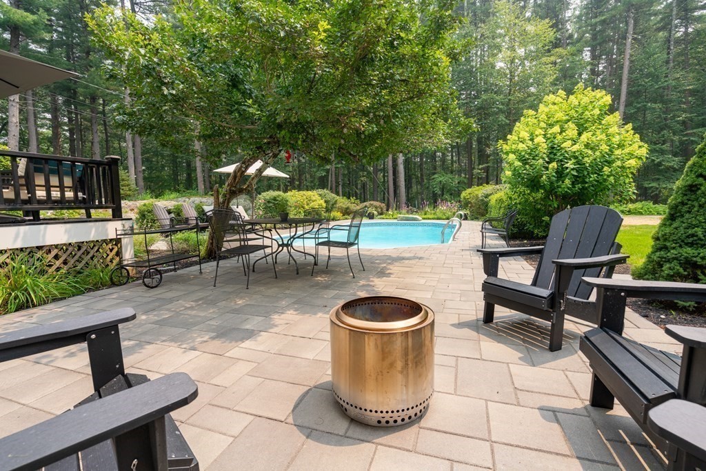 114 Still River Road Harvard, MA 01451 - Photo 7 of 42 a view of a patio with table and chairs potted plants and a large tree