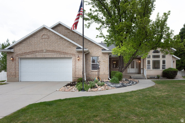 875 East 1300th Street North Mapleton, UT 84664 - Photo 61 of 65 Ranch-style house with an attached garage, driveway, a front yard, and brick siding
