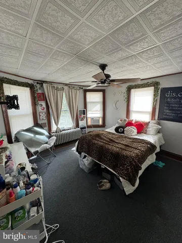 a bedroom with furniture and a window