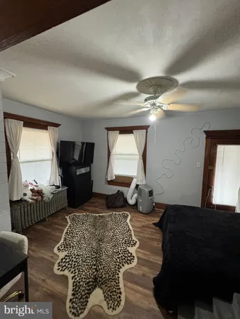 a living room with furniture a air conditioner vent and a window