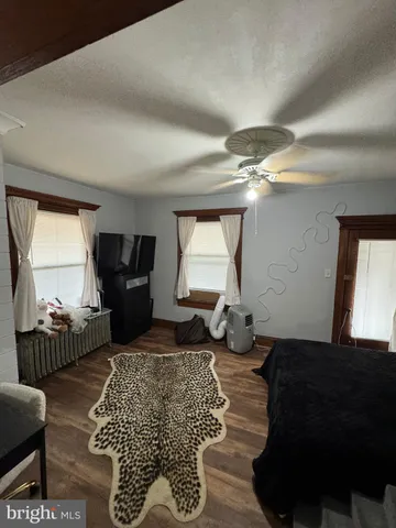 a living room with furniture a air conditioner vent and a window