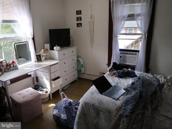 a bedroom with bed and window