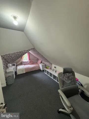 a bedroom with bed and window