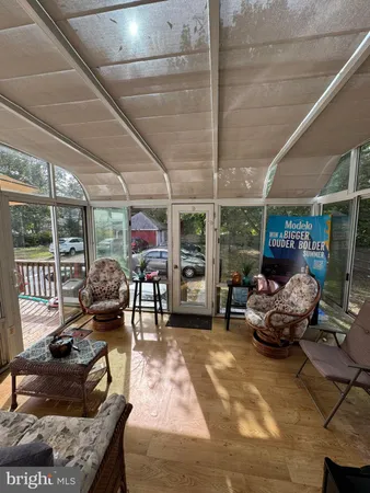 a view of a living room and furniture in wooden floor