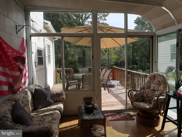 a view of a balcony with wooden floor and fence