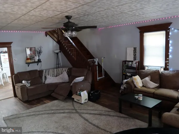 a living room with lots of furniture and gym equipment